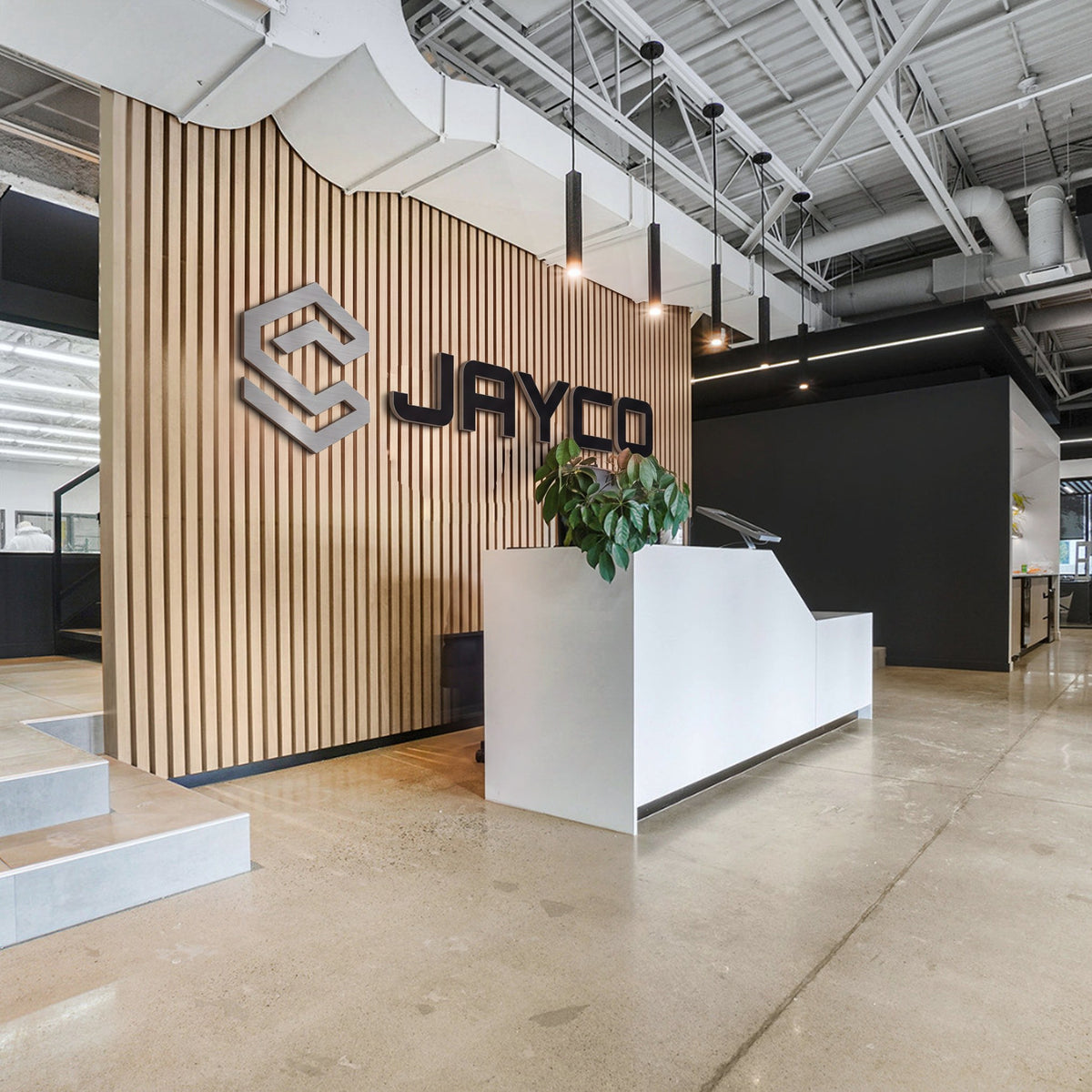 Réception du siège social de Capital Jayco à Longueuil, mur de lattes de bois et enseigne Jayco